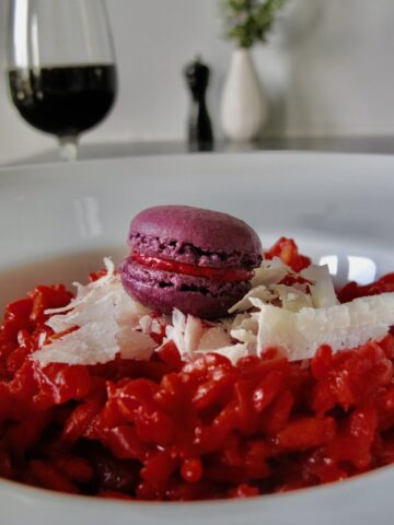 beet risotto with macaron and glass red wine