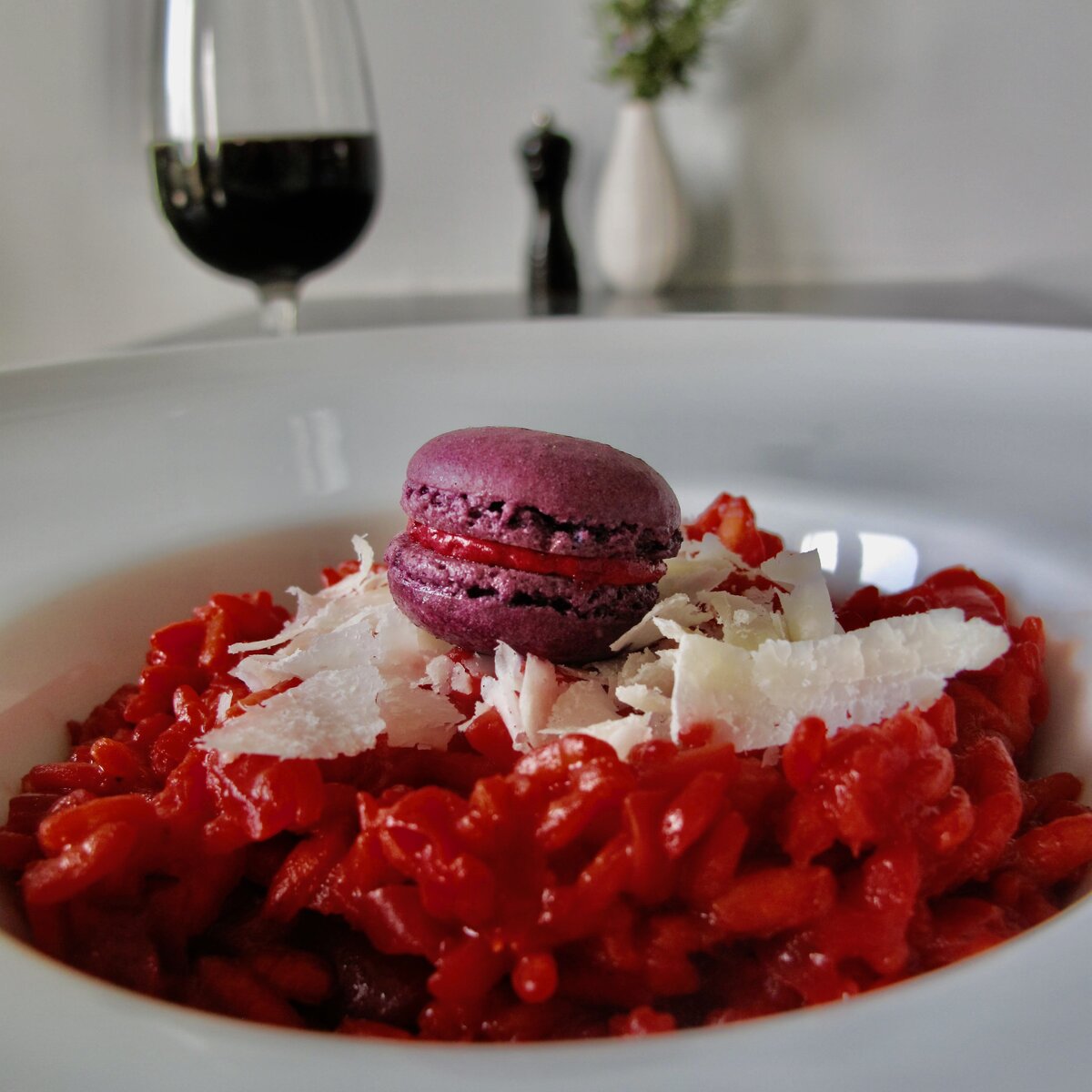 beet risotto with macaron and glass red wine