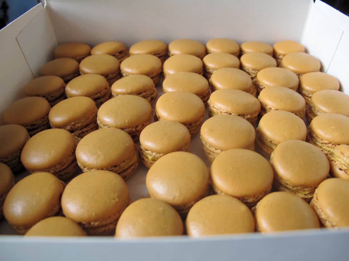 box of shiny little caramel brown macarons