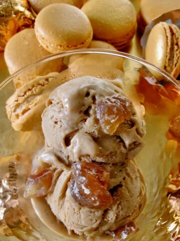scoops of light chestnut coloured ice cream topped with candied chestnuts