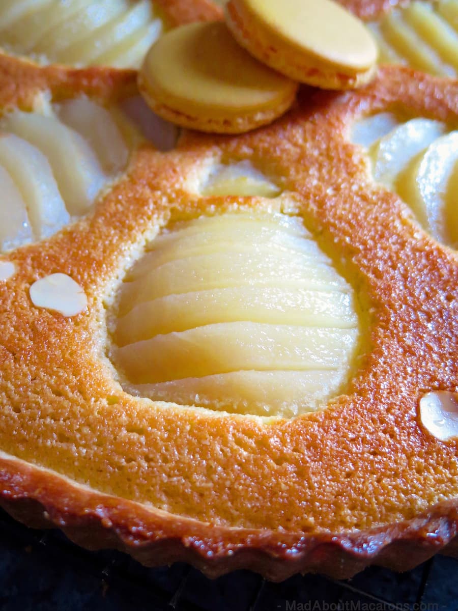 golden almond pear tart with 2 yellow macaron shells