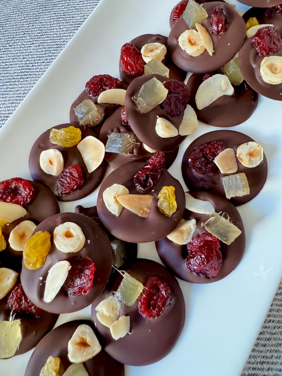 mendiant chocolate disks topped in toasted nuts and dried fruits