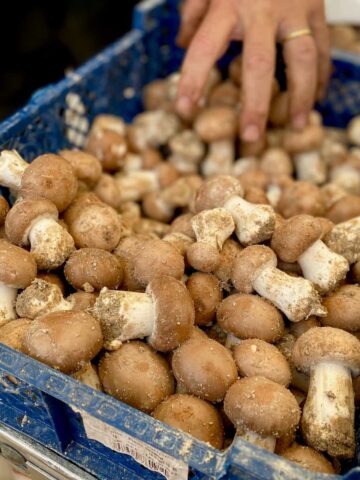 crate of Parisian chestnut mushrooms at the French market