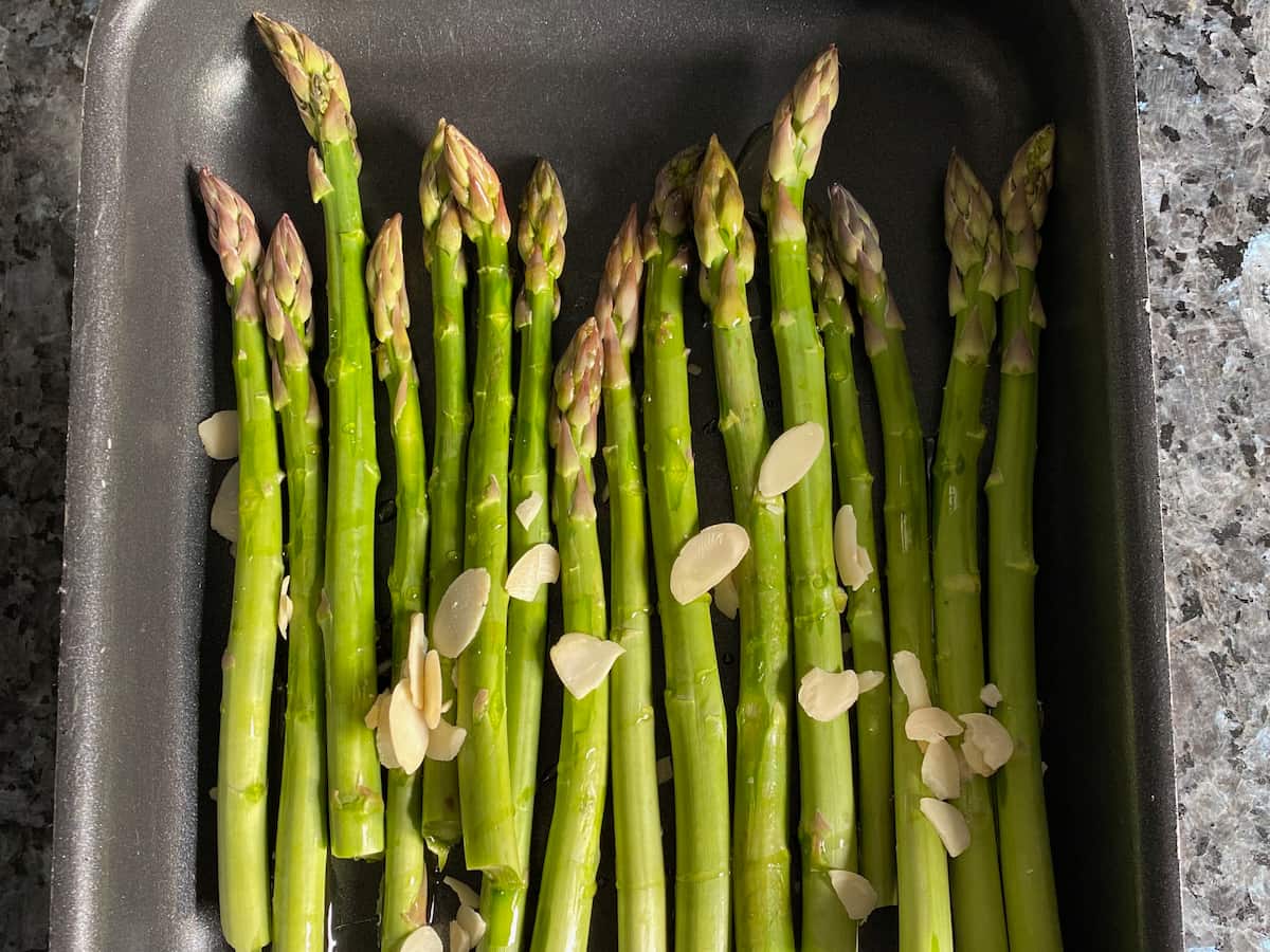 asparagus with flaked almonds in roasting tin