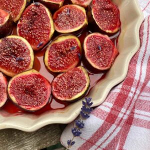 halved baked figs in a dish in a honey and port sauce