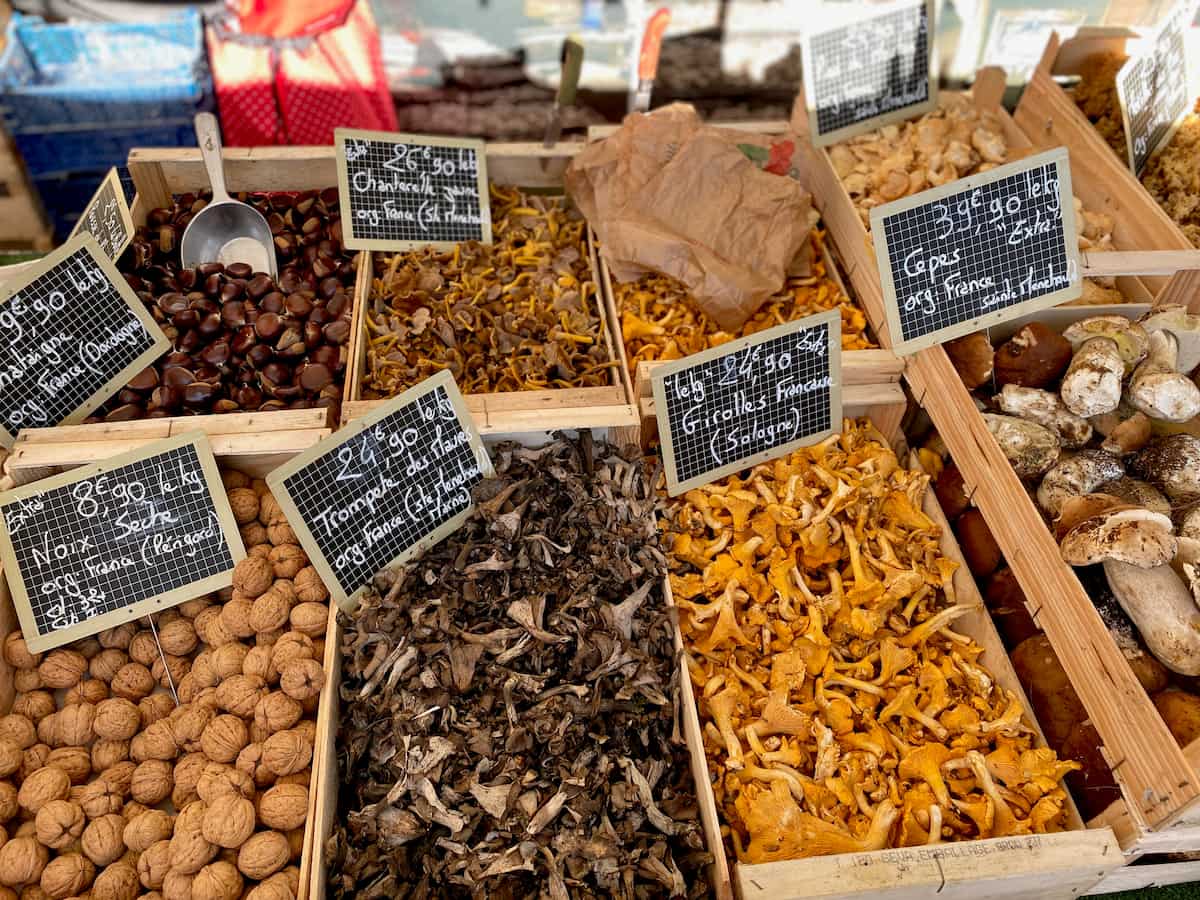 boxes of French mushrooms at the market with main types of edible wild mushrooms