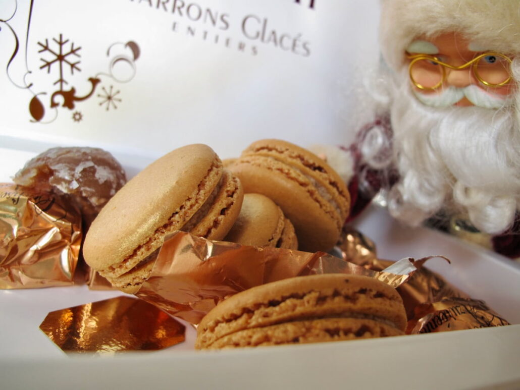 santa looking at macarons in a box