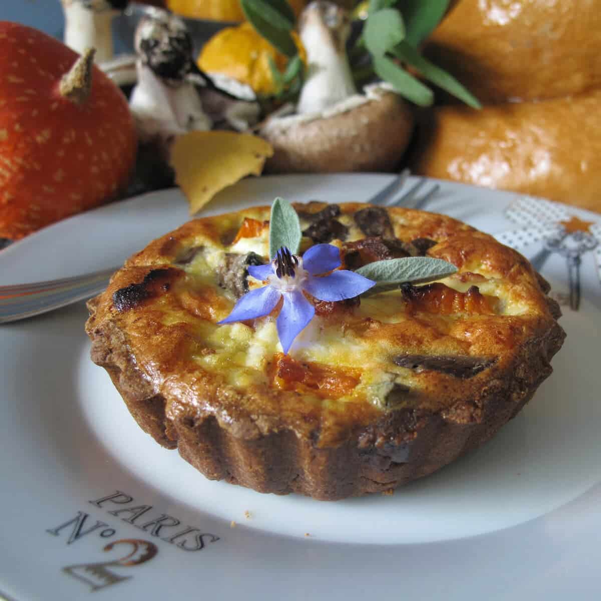 chestnut pumpkin and mushroom tart with borage flower