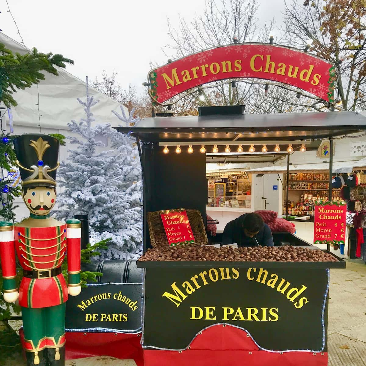 nutcracker soldiers in front of a hot chestnut stand in Paris