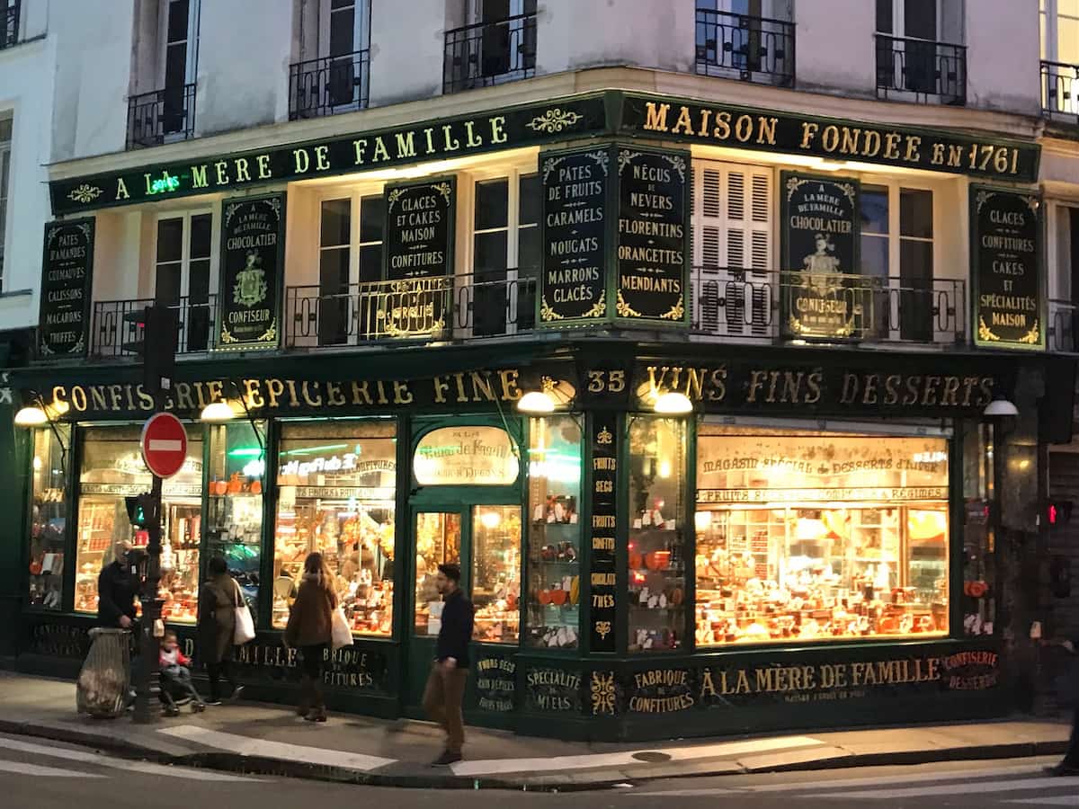 historical chocolate shop in Paris lit up at night
