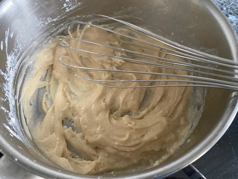 whisking together a paste or roux in a saucepan