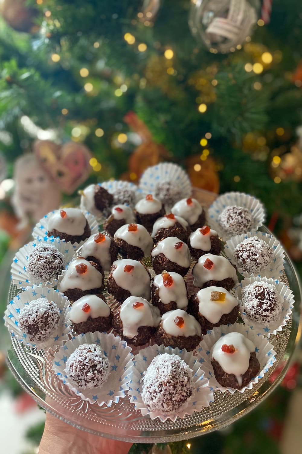 plate of mini christmas pudding bites in front of the tree