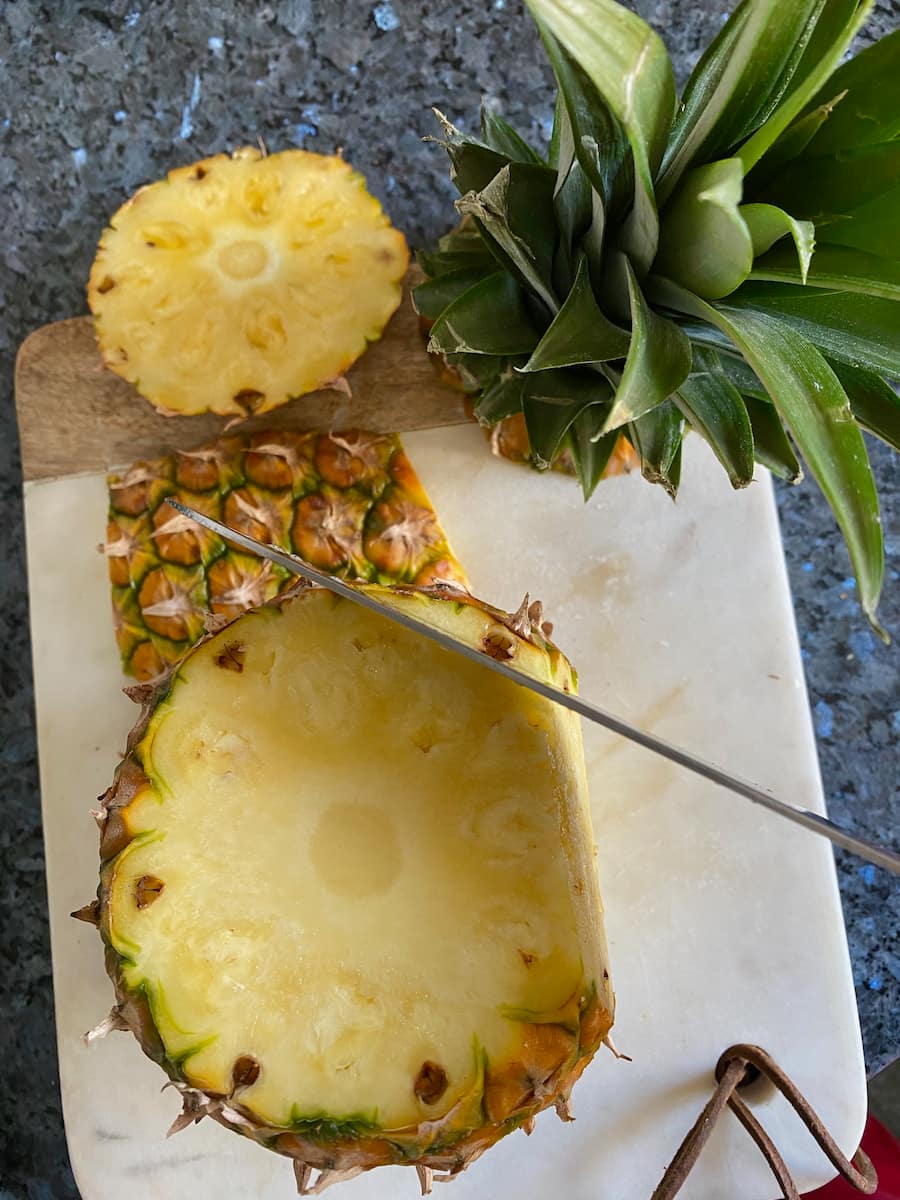 cutting off the pineapple skin