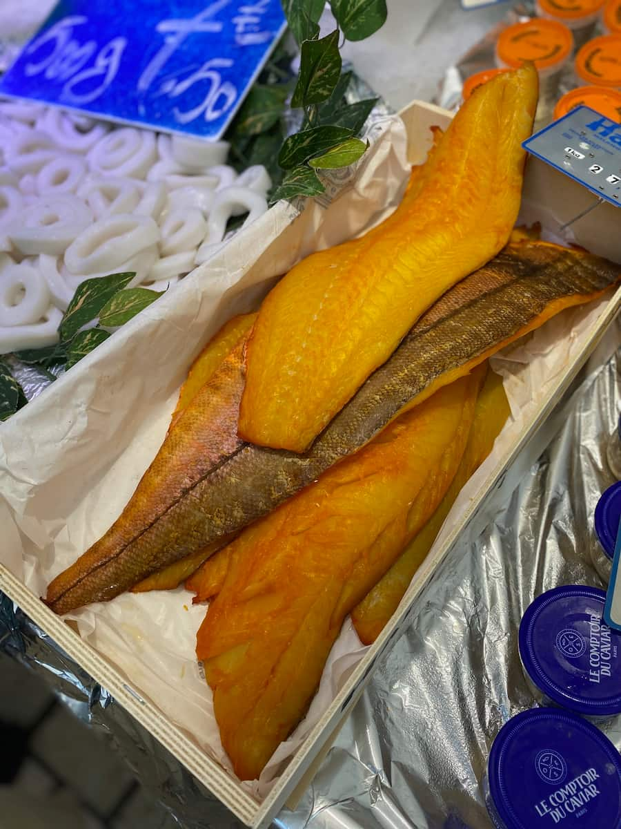 crate of yellow smoked fish at market