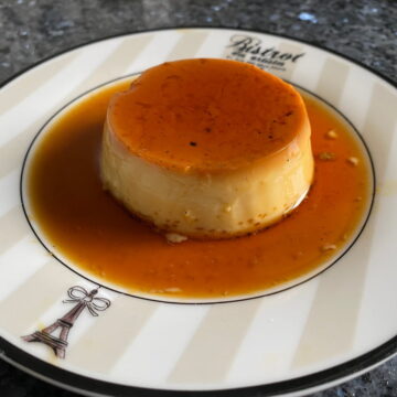 plate of creme caramel sitting in a pool of amber liquid caramel sauce