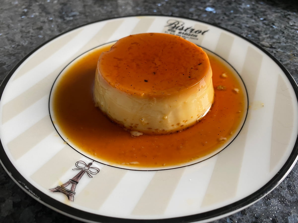 plate of creme caramel sitting in a pool of amber liquid caramel sauce