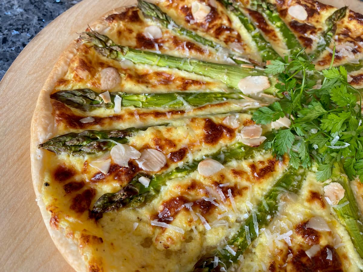 close up of a creamy crusty asparagus tart