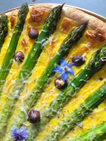 asparagus spears like sun rays on a tart
