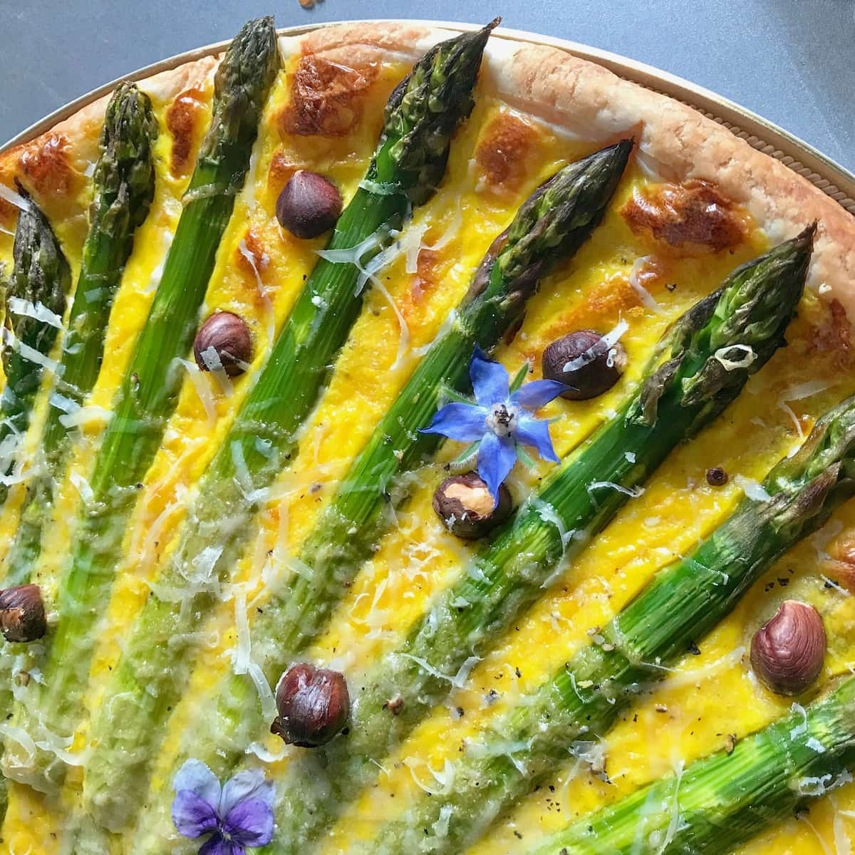 asparagus spears like sun rays on a tart