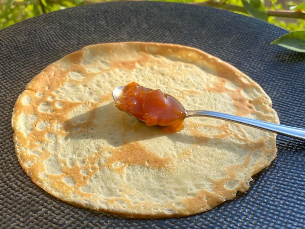 thin pancake with a spoonful of jam