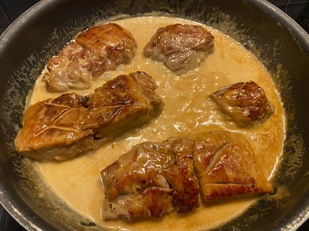 pork slices in honey sauce in a pan