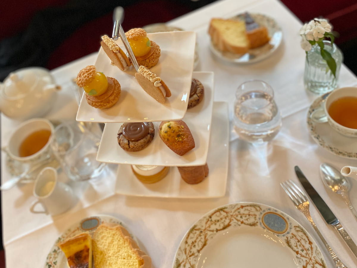 Paris teatime guide with teacakes on 3-tier stand with cups of tea
