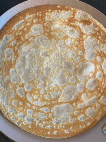 round crepe pancake perfectly cooked in a pan