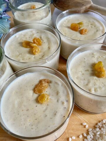 glass bowls of rice puddings topped with golden sultana raisins
