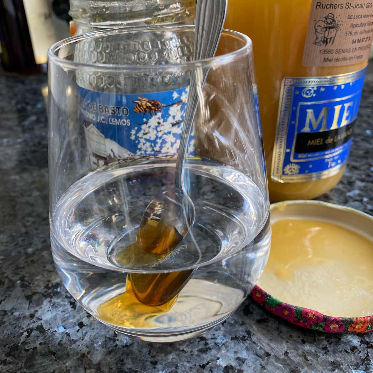 spoon of honey in glass of water