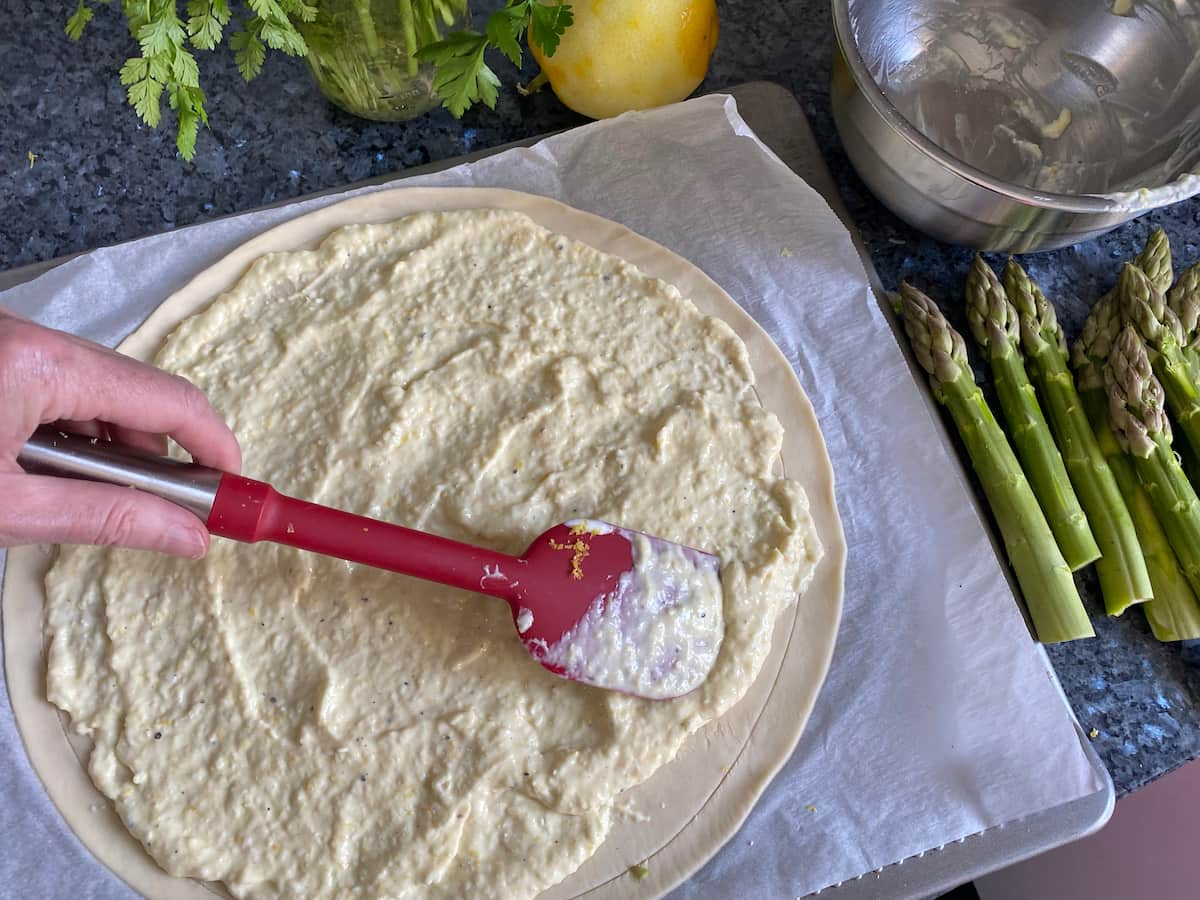 spreading on lemon parmesan cream on puff pastry