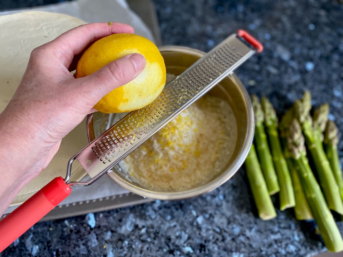 grating lemon and parmesan into bowl
