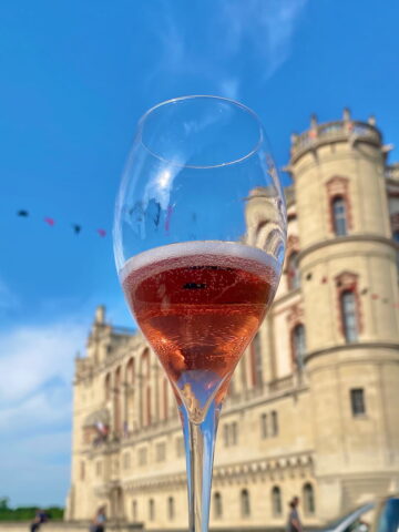 Kir Royal cocktail in front of a French chateau
