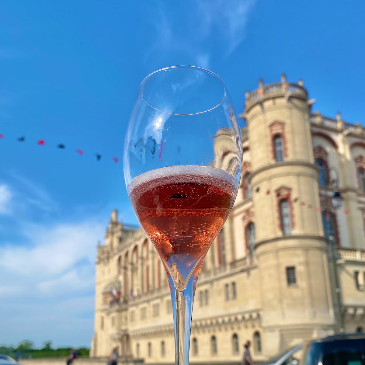 Kir Royal cocktail in front of a French chateau
