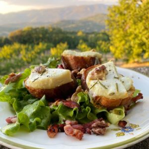 slices of toasted bread with cheese, nuts, lettuce and bacon