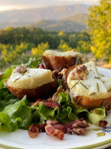 slices of toasted bread with cheese, nuts, lettuce and bacon