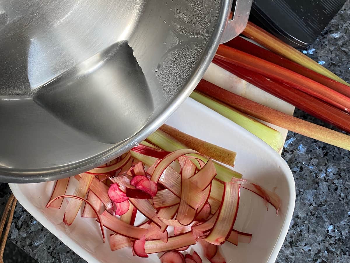 pouring syrup over thin rhubarb slices