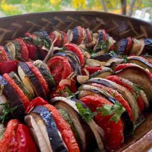 stacked sliced tomatoes, zucchini, onion and eggplant