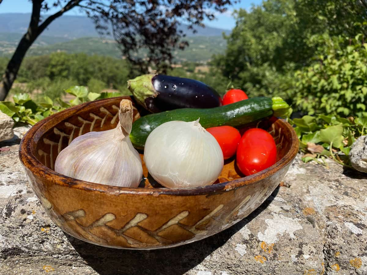 onion, garlic, tomatoes, aubergine and courgette in a dish