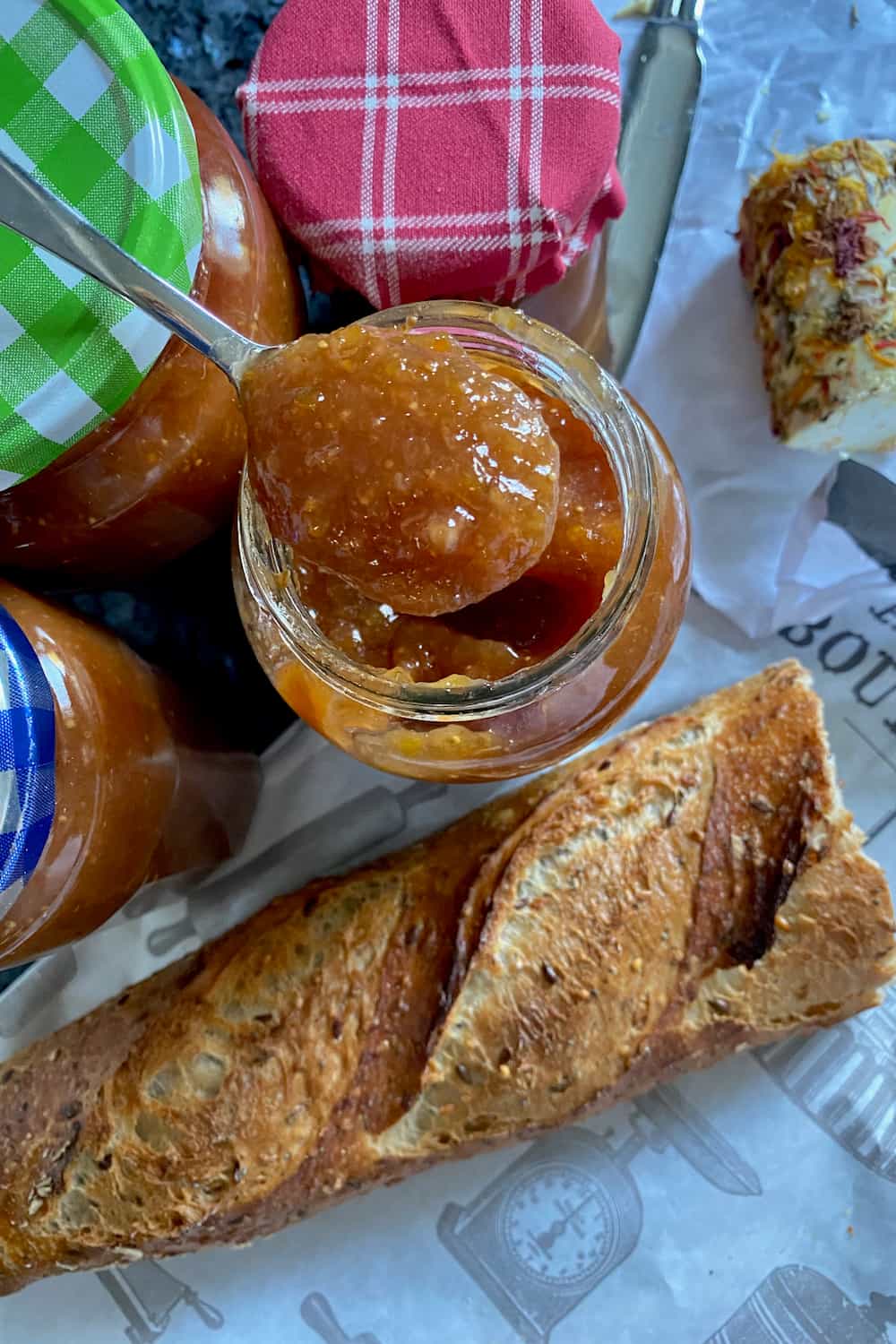 spoon of fig jam with French bread and cheese
