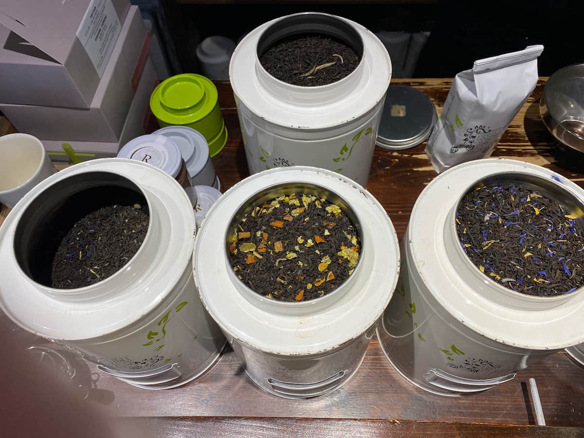 large tea tins with loose tea leaves