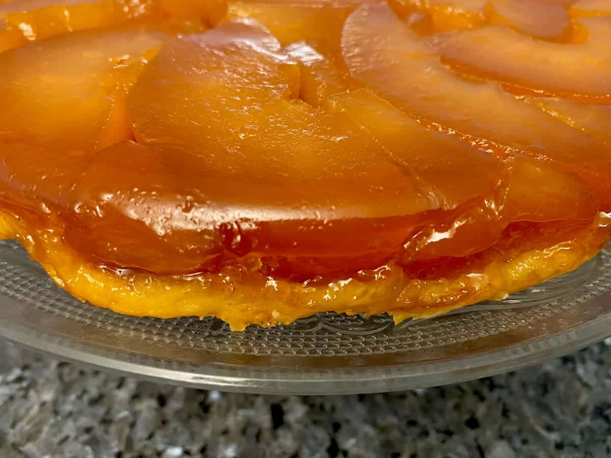 tarte tatin - an upside down apple tart glistening with golden caramel