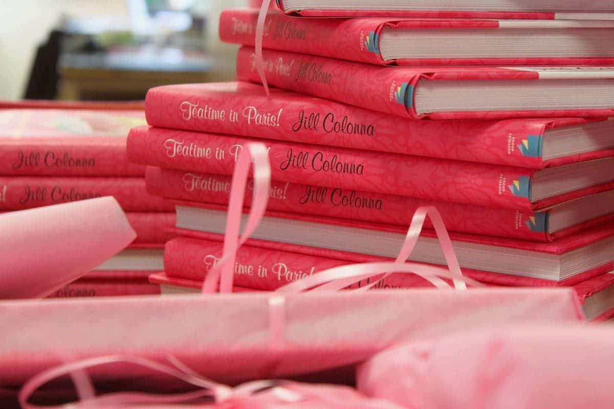 stack of pink recipe books