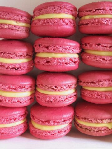 box of pink macarons with lemon yellow filling