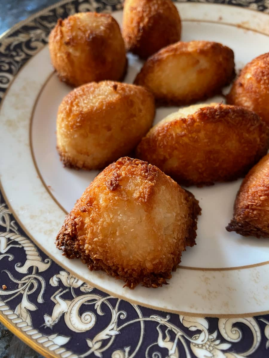 pyramid shaped baked coconut cookie - all bite sized on a decorated plate