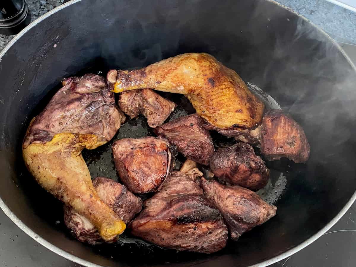 cooking the marinaded chicken in the pot first
