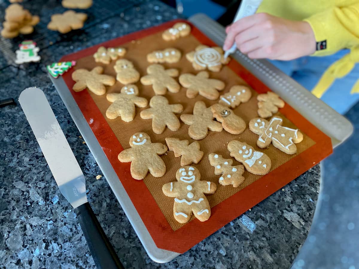 decorating gingerbread men cookies with white icing