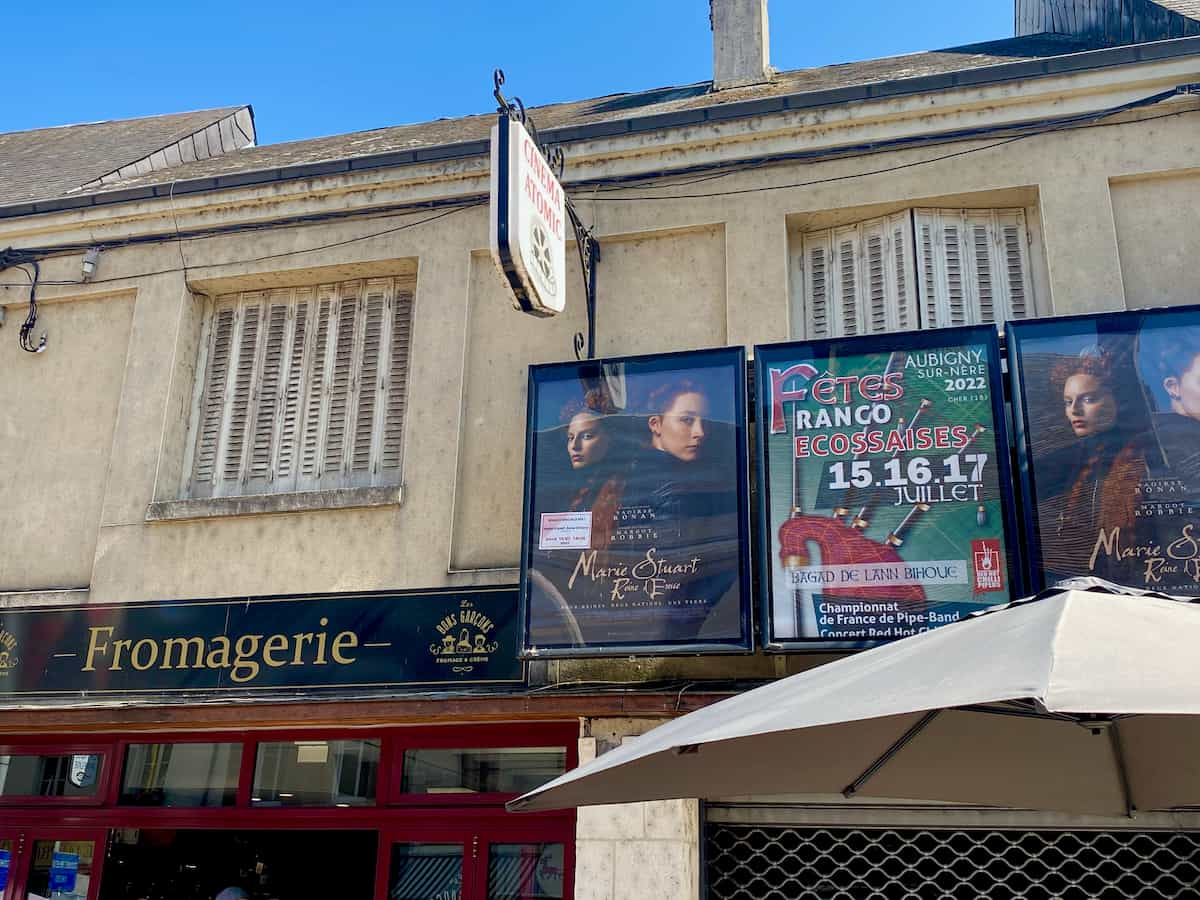 French cinema entrance next to a fromagerie cheese shop