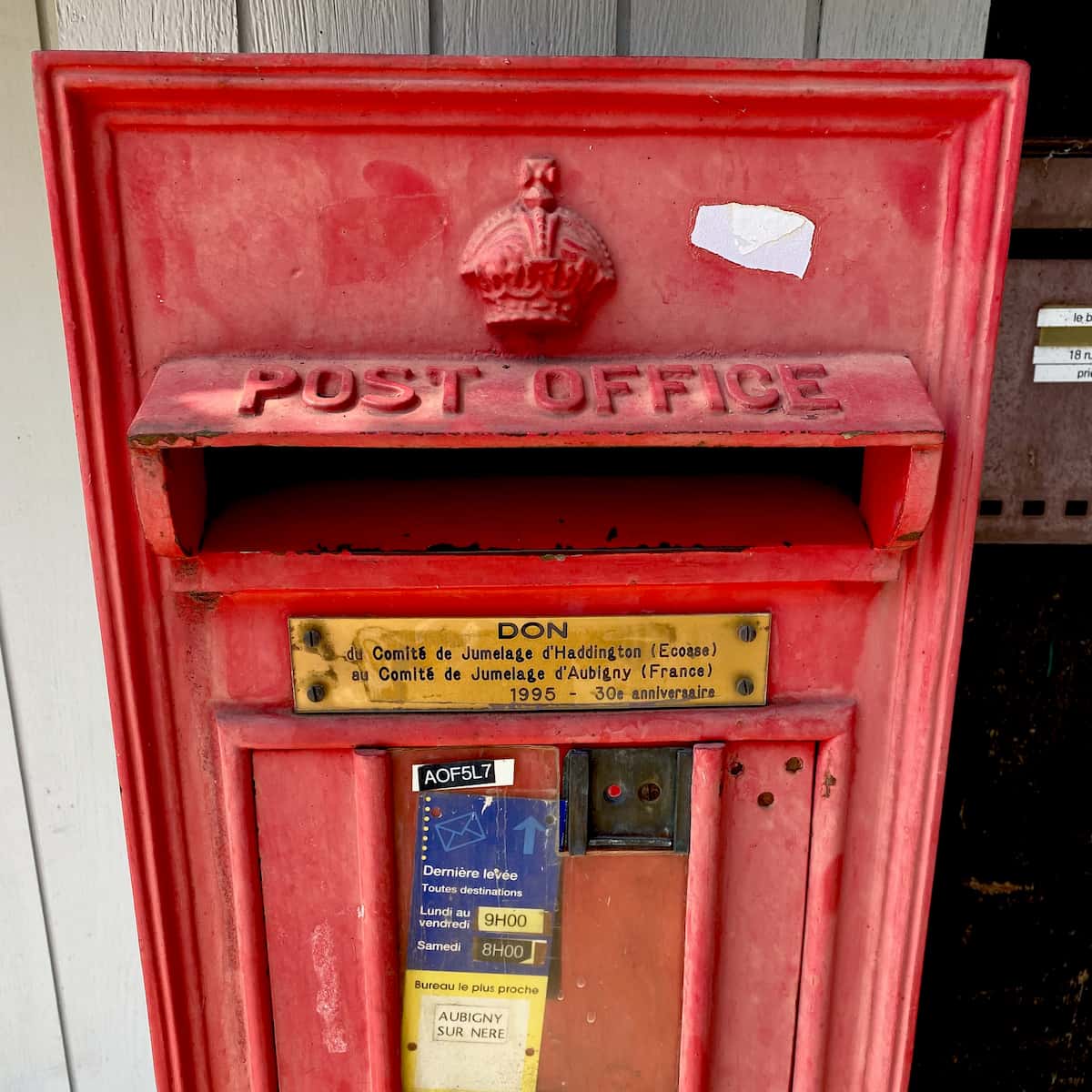 Red Scottish post box in France