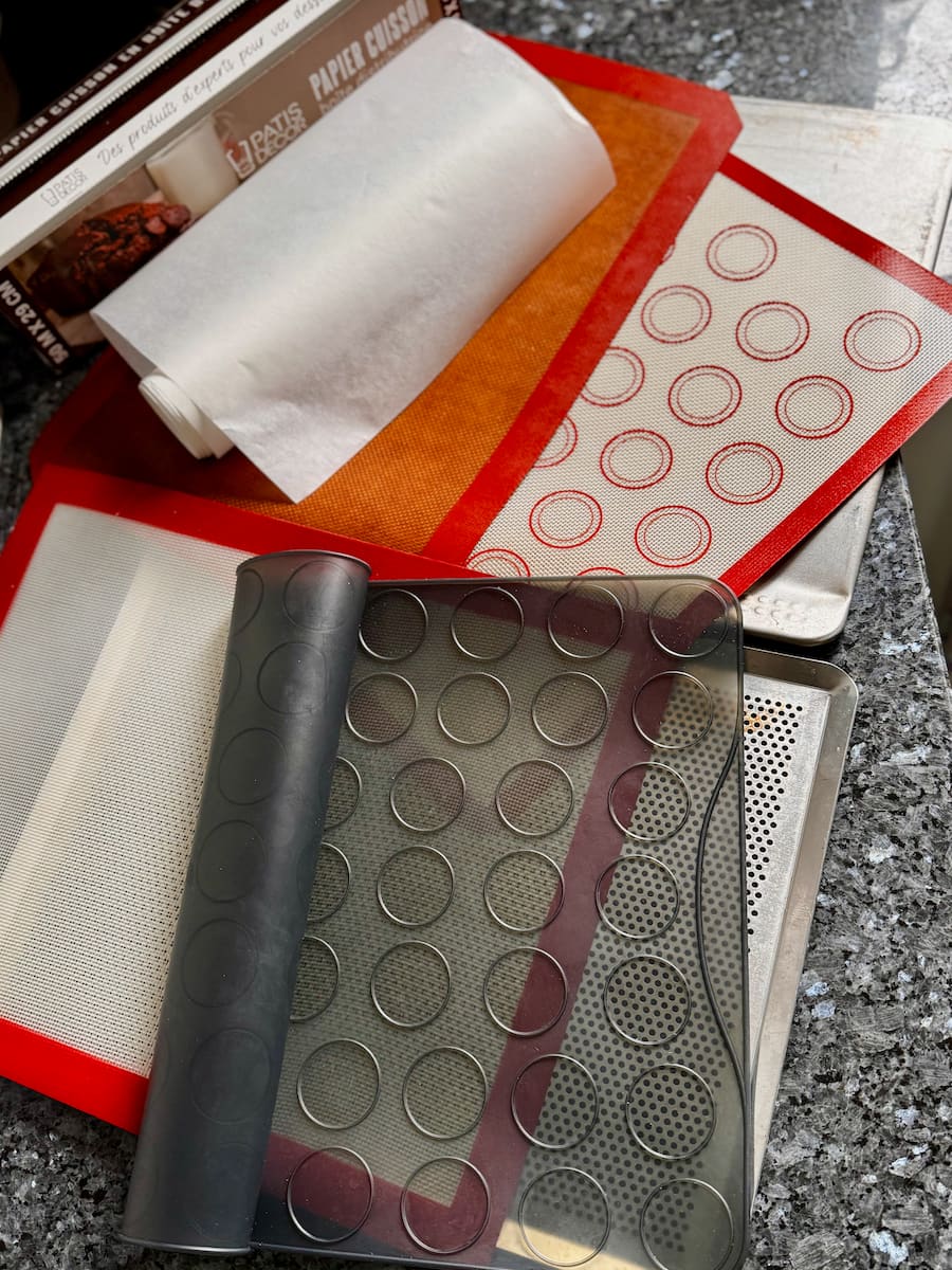 good quality baking parchment, silicone mats and macaron mats to make macarons