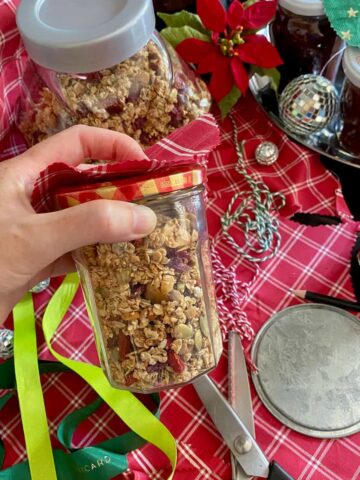 preparing jars of homemade granola for Christmas presents